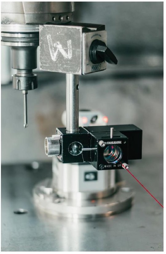 Renishaw Laser Interferometer optics mounted on a CNC machine spindle, with the measurement beam visible